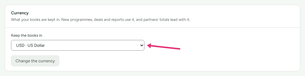 The Currency card on Settings › Workspace › Organization, with an arrow at Keep the books in.