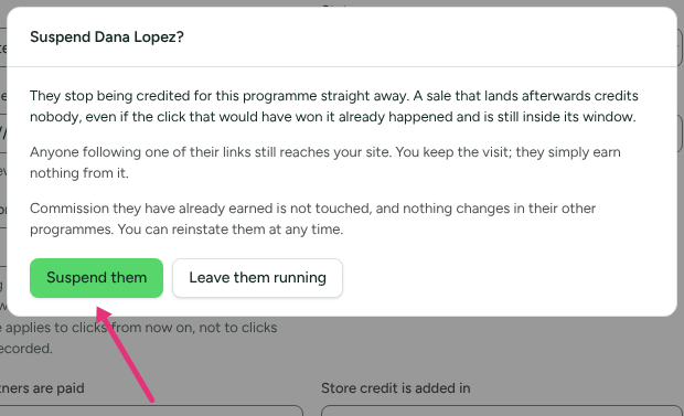 The Suspend dialog for a partner in Affiliate Program, explaining what stops and what does not, with an arrow at Suspend them.